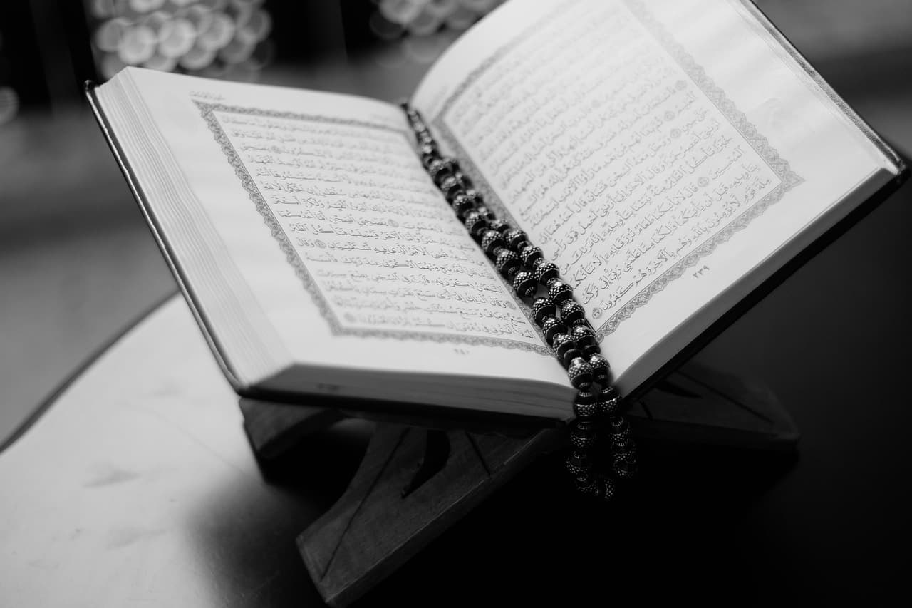 Open Quran with prayer beads