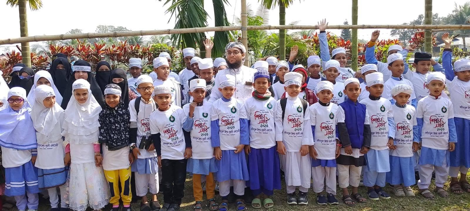 Students and their teacher in study tour shirts before setting off